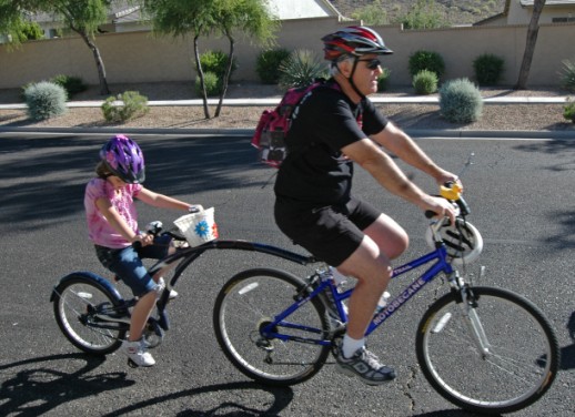 kids ride behind bike
